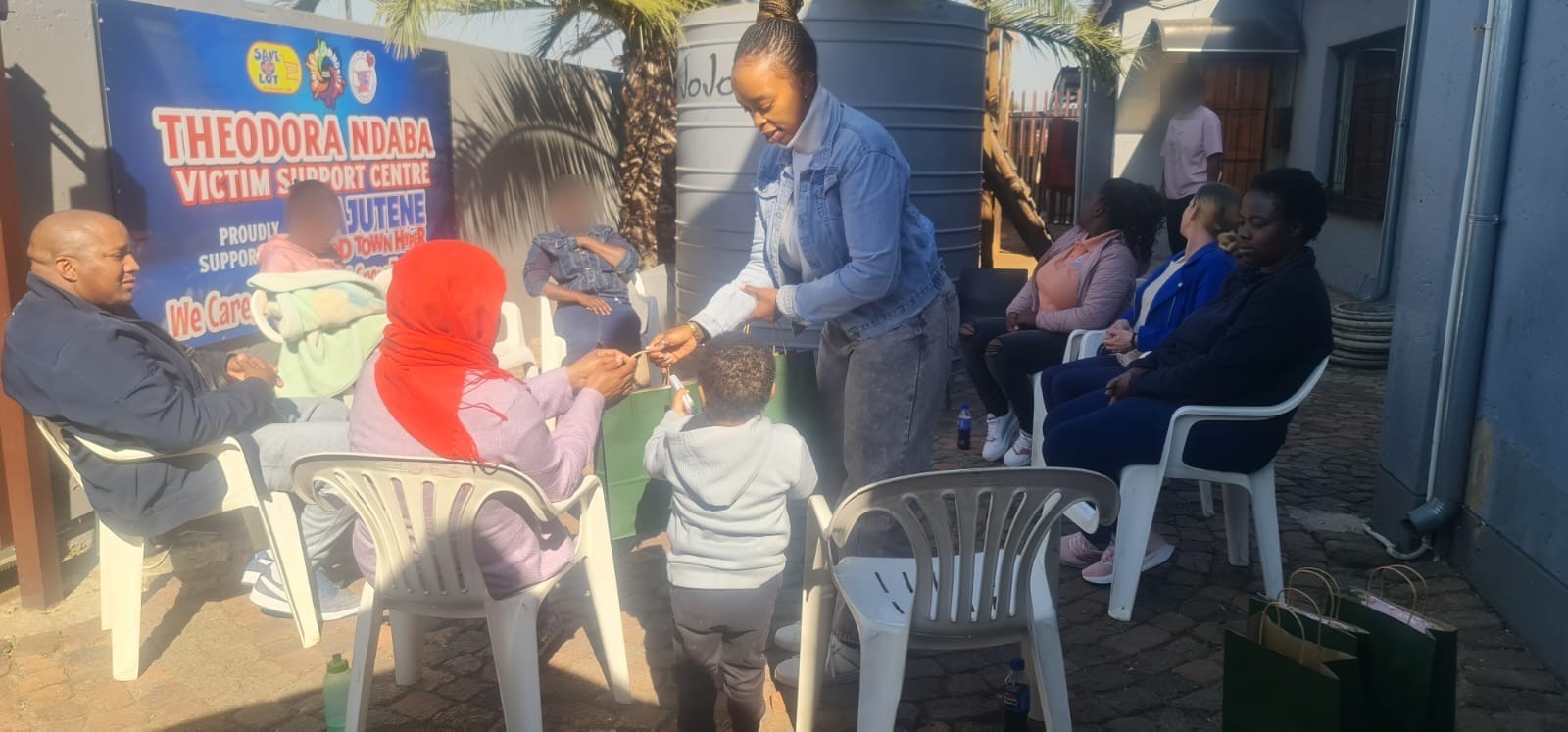 A volunteer handing a gift bag to a child